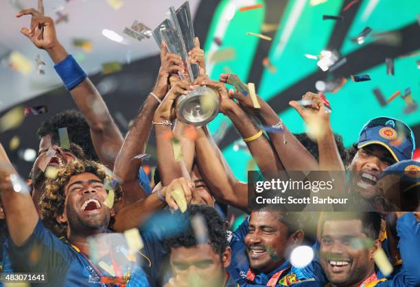 Lasith Malinga of Sri Lanka and his team celebrate with the trophy on the podium after winning the Final of the ICC World Twenty20 Bangladesh 2014...