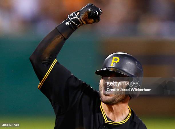 Francisco Cervelli of the Pittsburgh Pirates reacts following his triple in the 8th inning before scoring against the Chicago Cubs during the game at...