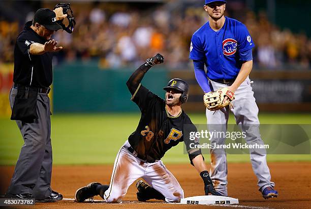 Francisco Cervelli of the Pittsburgh Pirates reacts following his triple in the 8th inning before scoring against the Chicago Cubs during the game at...