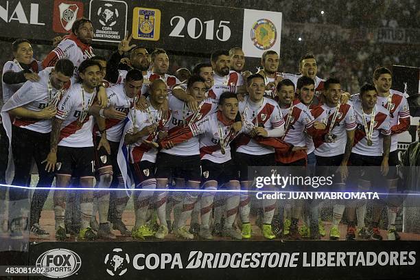 Argentina's River Plate players celebrate on the podium after defeating Mexico's Tigres 3-0 in the Libertadores Cup final at Americo Vespucio...