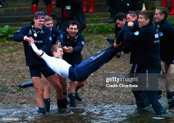 Cox Laurence Harvey of Cambridge is thrown into the Thames by his crew after victory during the BNY Mellon 160th Oxford versus Cambridge University...