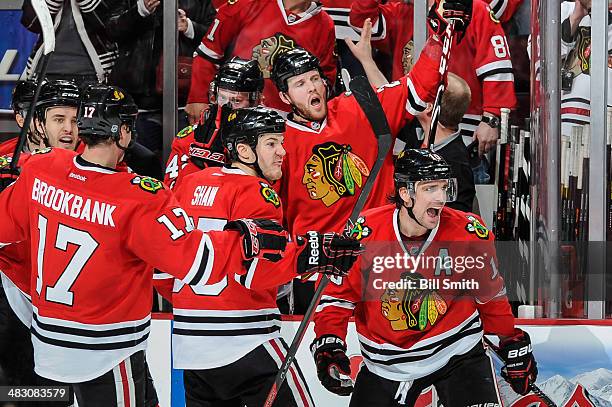Patrick Sharp of the Chicago Blackhawks celebrates with teammates including Niklas Hjalmarsson, Andrew Shaw and Bryan Bickell after scoring against...