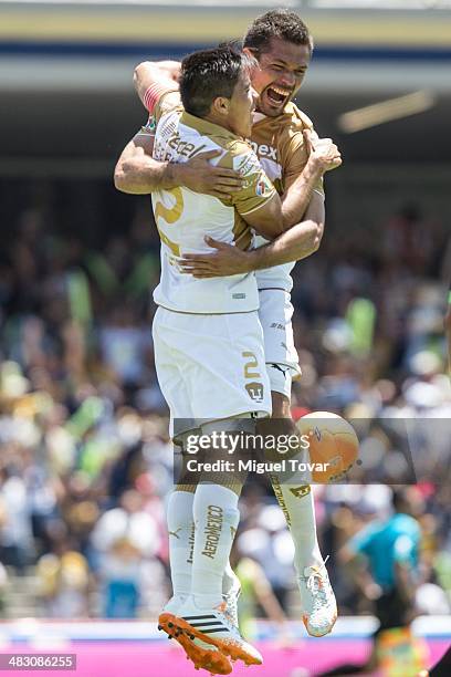 Dante Lopez of Pumas celebrates with Efrain Velarde after scoring his second goal during a match between Pumas UNAM and Chiapas as part of the 14th...