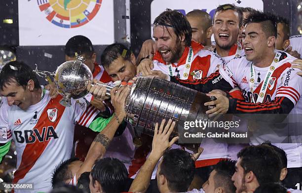 Fernando Cavenaghi of River Plate holds the trophy as he celebrates with his teammates after winning a final match between River Plate and Tigres...