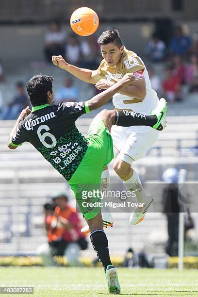 Efrain Velarde of Pumas fights for the ball with Luis Robles of Jaguares during a match between Pumas UNAM and Chiapas as part of the 14th round...