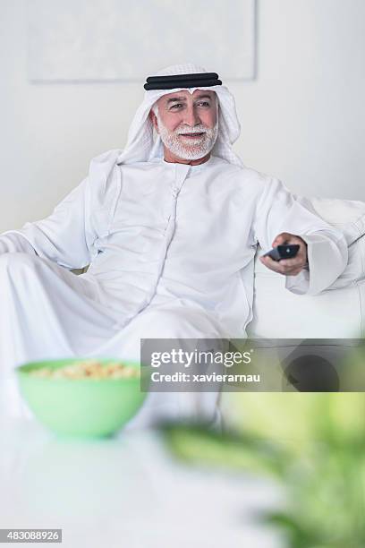 watching television - old arab man stock pictures, royalty-free photos & images