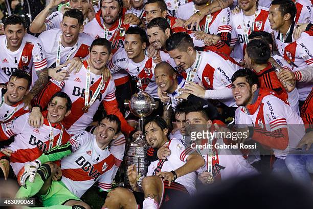 Players of River Plate pose for a team photo with their trophy after winning a final match between River Plate and Tigres UANL as part of Copa...