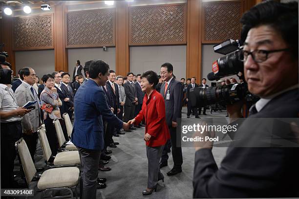South Korea's President Park Geun-Hye shakes hands with officials and audience members after delivering a speech duriung a live television broadcast...