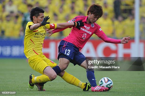 Takumi Minamino of Cerezo Osaka and Hidekazu Otani of Kashiwa Reysol compete for the ball during the J.League match between Kashiwa Reysol and Cerezo...