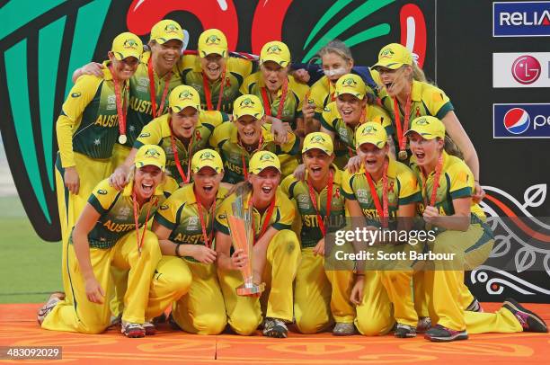 Captain Meg Lanning and the Australian team celebrate with the trophy on the podium after winning the Final of the ICC Women's World Twenty20...