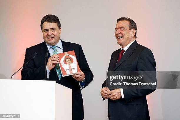 Sigmar Gabriel , German Economoy Minister and Chairman of the German Social Democrats , greets former German Chancellor Gerhard Schroeder at a...