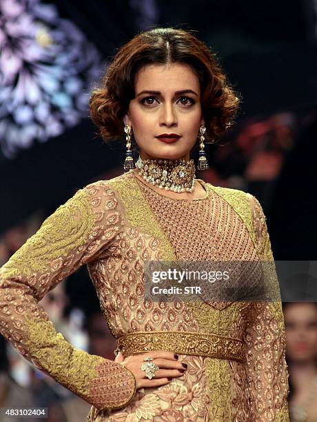 Indian Bollywood actress Dia Mirza showcases a creation during India International Jewellery Week 2015 in Mumbai on August 5, 2015. AFP PHOTO