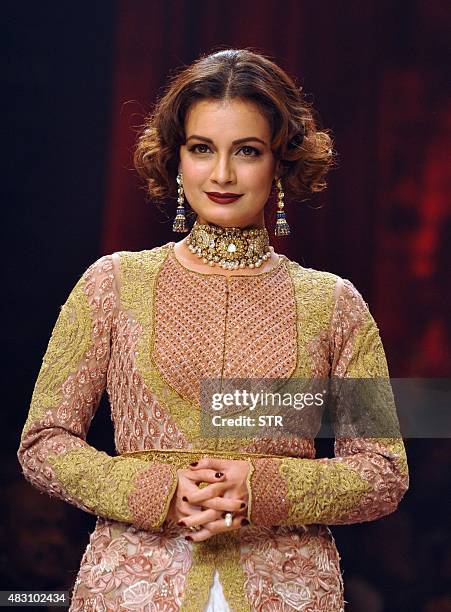 Indian Bollywood actress Dia Mirza showcases a creation during India International Jewellery Week 2015 in Mumbai on August 5, 2015. AFP PHOTO