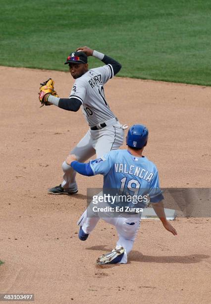 Alexei Ramirez of the Chicago White Sox throws past Danny Valencia of the Kansas City Royals to first but can't complete a double play in the sixth...
