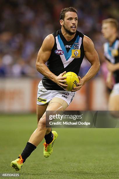 Travis Boak of the Power runs with the ball during the round three AFL match between the North Melbourne Kangaroos and the Port Adelaide Power at...