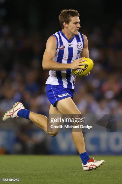 Shaun Atley of the Kangaroos runs with the ball during the round three AFL match between the North Melbourne Kangaroos and the Port Adelaide Power at...