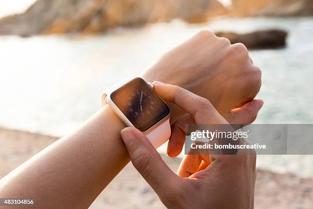 apple watch 42 mm stainless steel with white sport band - apple watch stock pictures, royalty-free photos & images