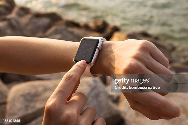 apple watch 42 mm stainless steel with white sport band - electronic form stock pictures, royalty-free photos & images