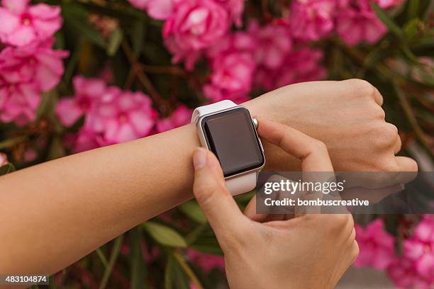 apple watch 42 mm stainless steel with white sport band - apple watch stock pictures, royalty-free photos & images