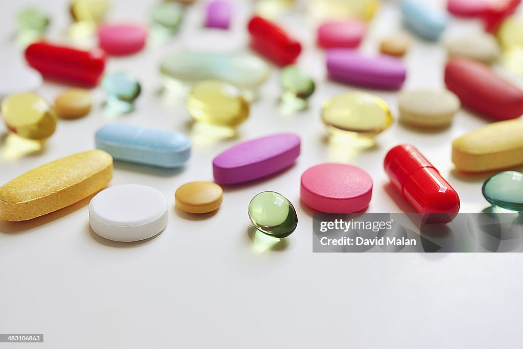 Various pills lying on a white surface