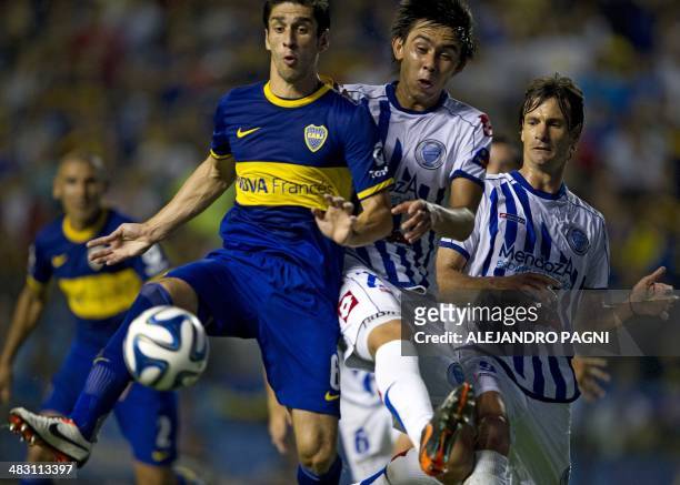 Boca Juniors' defender Juan Forlin vies for the ball with Godoy Cruz's defender Sebastian Olivares during their Argentine First Division football...