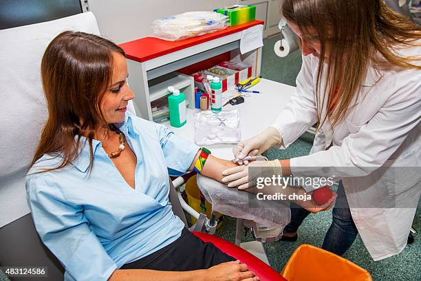 young woman is going to donate blood in  blood bank - blood type stock pictures, royalty-free photos & images