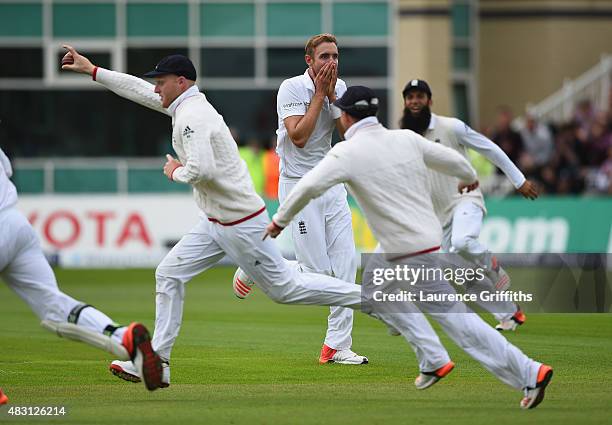 Stuart Broad of England looks on in disbelief at Ben Stokes after his amazing catch to dimiss Adam Voges of Australia during day one of the 4th...