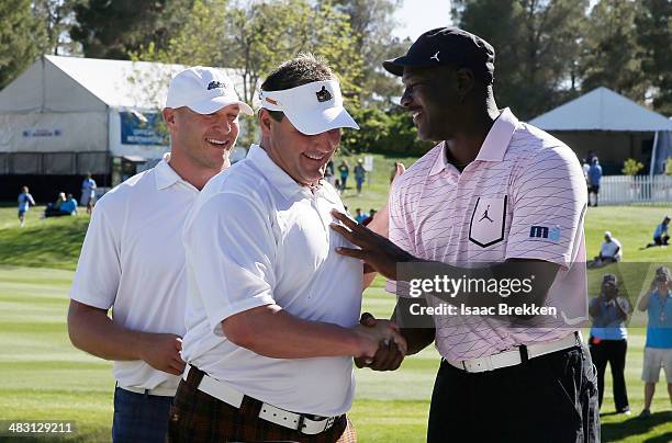 Legend Michael Jordan congratulates former NFL player Brian Urlacher and former MLB player Roger Clemens after they won Aria Resort & Casino's 13th...