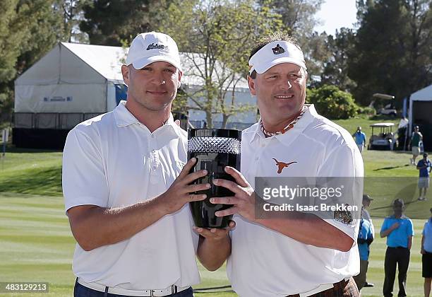 Former NFL player Brian Urlacher and former MLB player Roger Clemens pose with trophy after they winning Aria Resort & Casino's 13th Annual Michael...