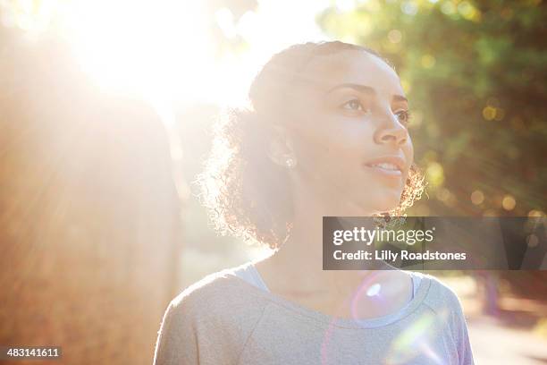 young woman dreaming in the sun - daydreaming teen stock pictures, royalty-free photos & images