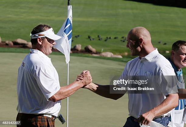 Former NFL player Brian Urlacher and former MLB player Roger Clemens high-five after they won Aria Resort & Casino's 13th Annual Michael Jordan...