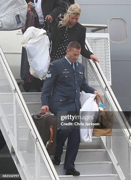 Luggage is carried off the plane as Catherine, Duchess of Cambridge, Prince William, Duke of Cambridge and Prince George of Cambridge arrive at...