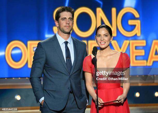 Quarterback Aaron Rodgers and actress Olivia Munn speak onstage during the 49th Annual Academy of Country Music Awards at the MGM Grand Garden Arena...