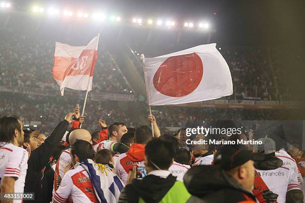 Players of River wave Japaneses flags to celebrate their victory in the second leg second leg final match between River Plate and Tigres UANL as part...