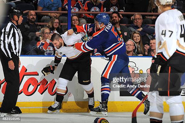 Mark Fraser of the Edmonton Oilers fights against Patrick Maroon of the Anaheim Ducks on April 6, 2014 at Rexall Place in Edmonton, Alberta, Canada.