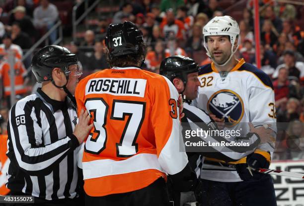 Jay Rosehill of the Philadelphia Flyers has a confrontation with John Scott of the Buffalo Sabres in the third period on April 6, 2014 at the Wells...