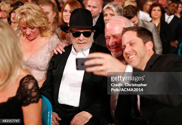 Theresa Ann Lane and recording artist Merle Haggard take a selfie with fans during the 49th Annual Academy of Country Music Awards at the MGM Grand...