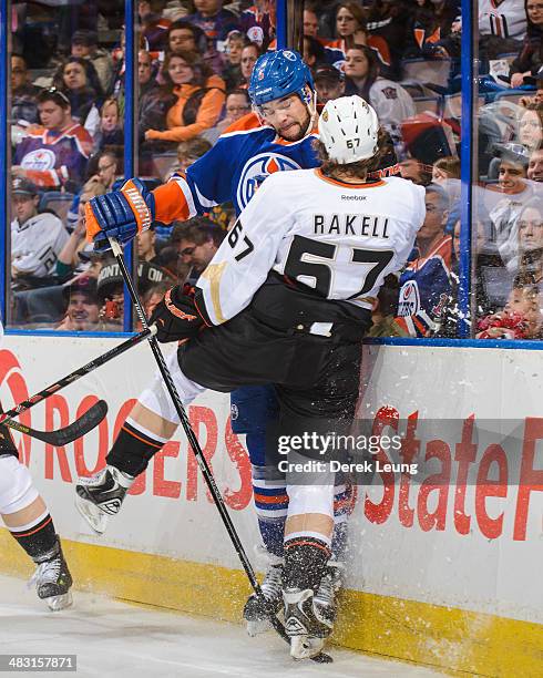 Mark Fraser of the Edmonton Oilers collides with Rickard Rakell of the Anaheim Ducks during an NHL game at Rexall Place on April 6, 2014 in Edmonton,...