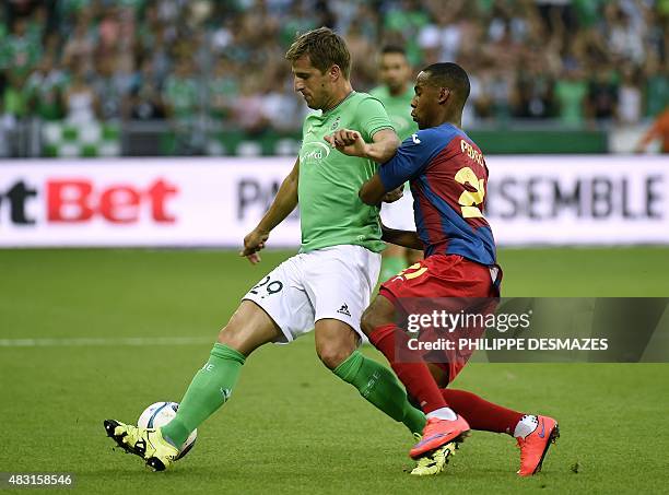 Saint-Etienne's French defender Francois Clerc vies with Targu Mures' Dutch midfielder Luis Pedro during the UEFA Europa League third qualifying...