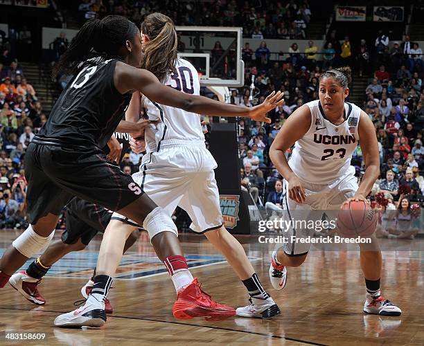 Brianna Banks of the Connecticut Huskies drives against Chiney Ogqumike of the Stanford Cardinal at Bridgestone Arena on April 6, 2014 in Nashville,...