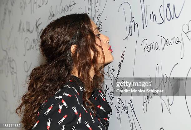 Actress, director and producer Salma Hayek signs and kisses the wall at AOL BUILD Speaker Series: "Kahlil Gibran's The Prophet" at AOL Studios In New...