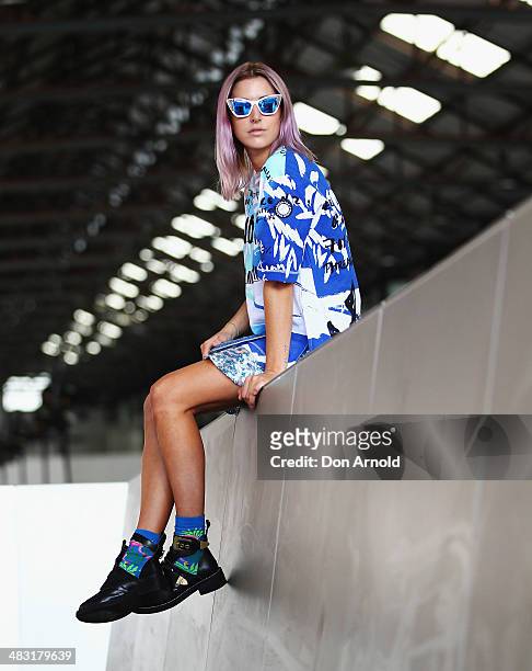 Poppy Lissiman wears a Kenzo top, Three Floor skirt, Balenciaga shoes and Karen Walker glasses at Mercedes-Benz Fashion Week Australia 2014 at...