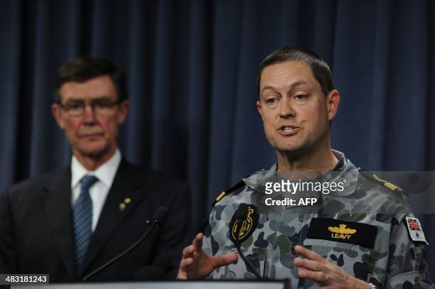 Commodore Peter Leavy of the Royal Australian Navy speaks as Angus Houston , head of the Joint Agency Coordination Centre leading the search for...