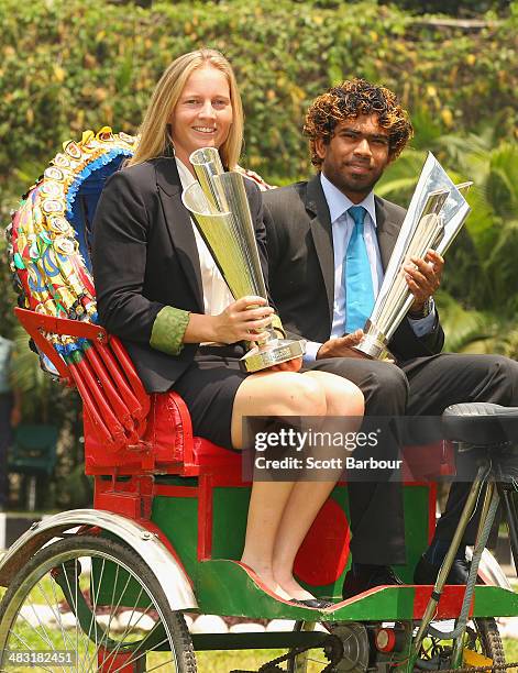 Meg Lanning, captain of Australia and Lasith Malinga, captain of Sri Lanka pose with the trophies on a rickshaw during a photocall after winning the...