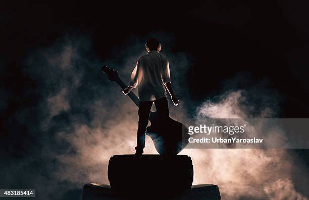 Rock musician and large guitar, a lot of smoke