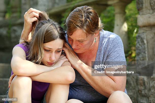 mother consoling dejected daughter - children divorce bildbanksfoton och bilder