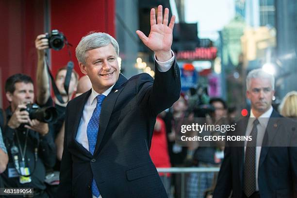 Conservative leader Prime Minister Stephen Harper waves to supporters as he arrives for the first federal leaders debate of the 2015 Canadian...