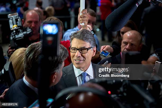 Rick Perry, former governor of Texas and 2016 Republican presidential candidate, speaks to the media in the spin area after a televised forum ahead...