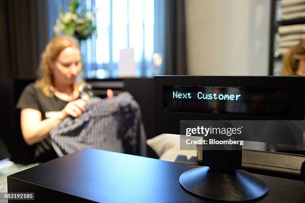 The screen of a cash register calls for the next customer at the checkout counters inside a Hennes & Mauritz AB fashion store in Melbourne,...