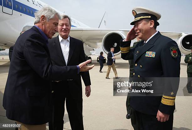 Secretary of Defense Chuck Hagel is welcomed by Rear Admiral Guan Youfei , Director of Foreign Affairs Office of the Chinese Defense Ministry and...